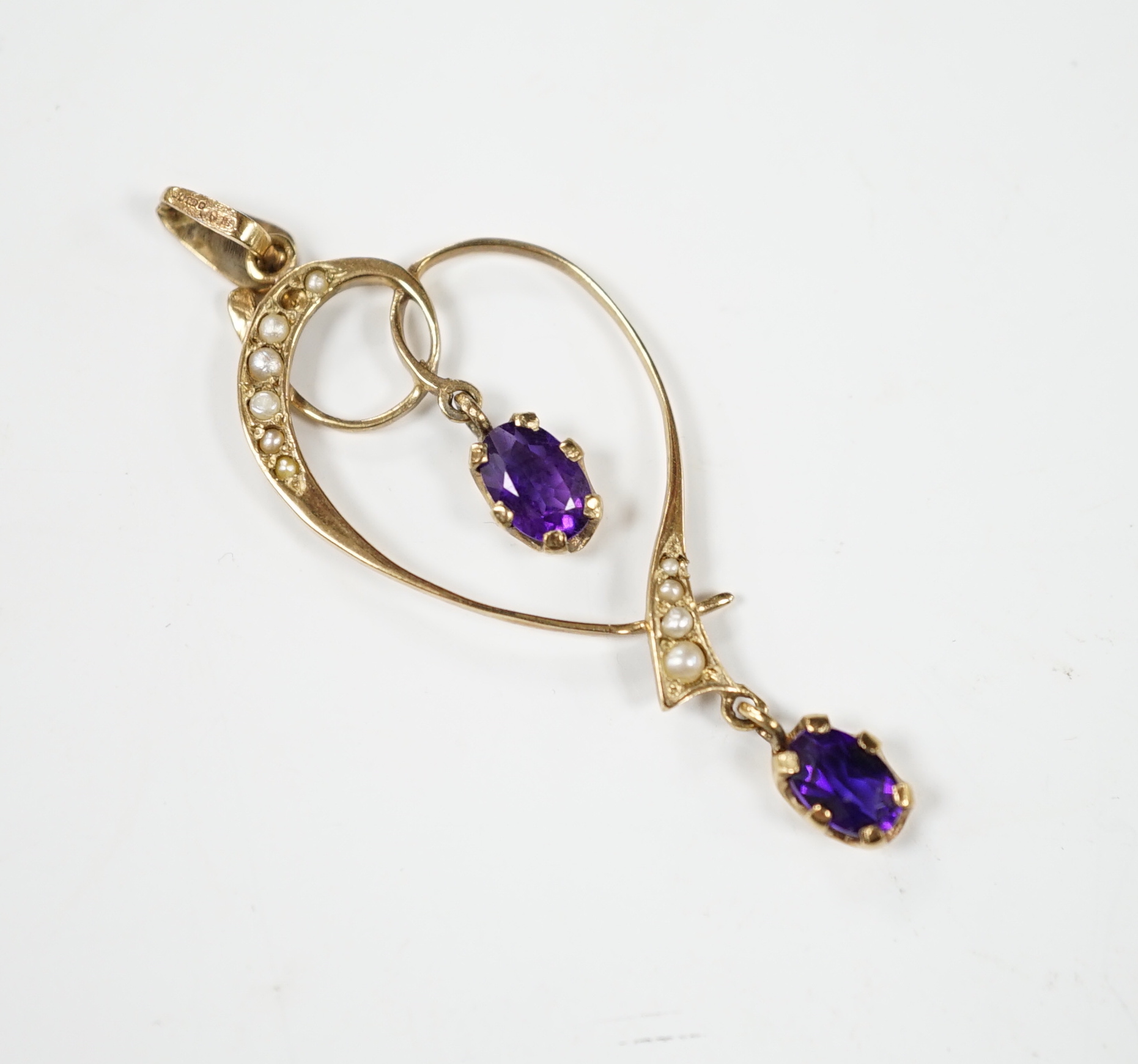 A modern Edwardian style 9ct gold, amethyst and seed pearl set drop pendant, 45mm, gross weight 1.6 grams.